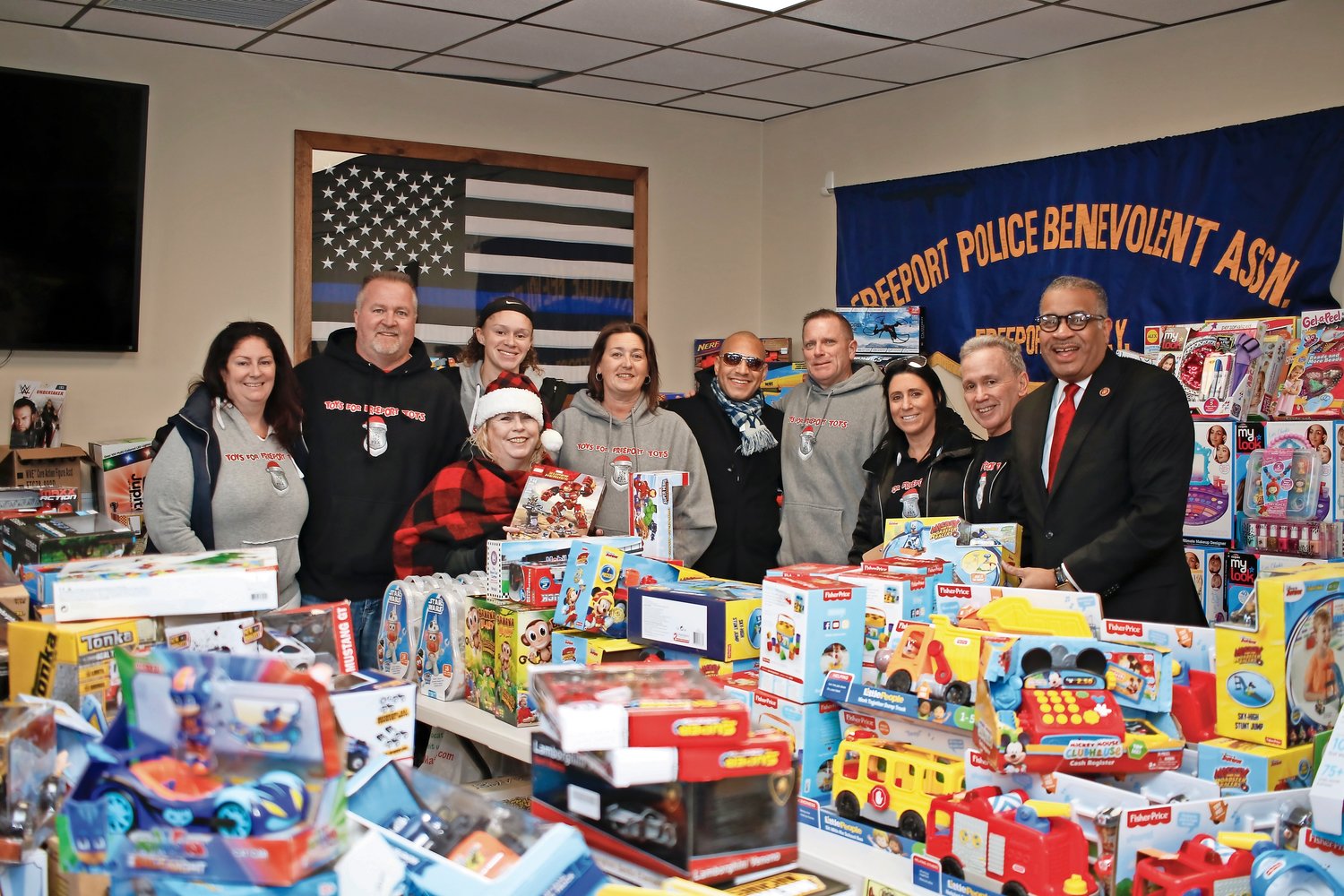 Detective Patrick Franzone, fourth from right, and his “elves” helped choose toys for the children at the annual Toys for Freeport Tots day at the Freeport PBA on Dec. 19.