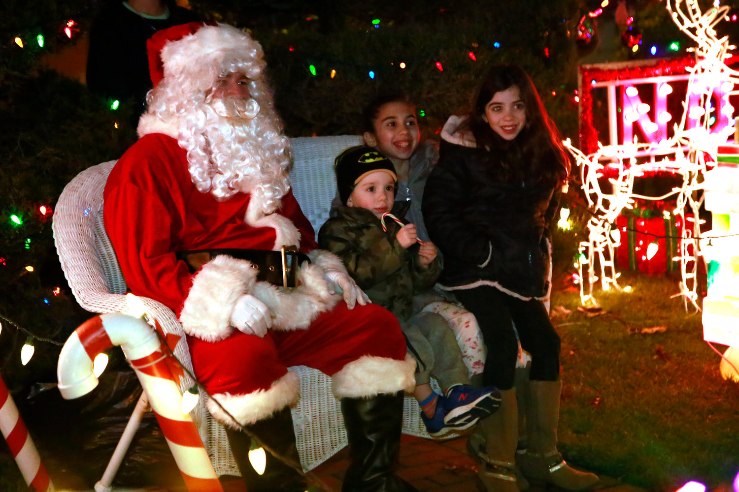 A highlight of the block party is a visit from Santa Claus, shown with the McGovern children, Matthew, 3, Ashlynn, 10 and Ava, 8, last year.
