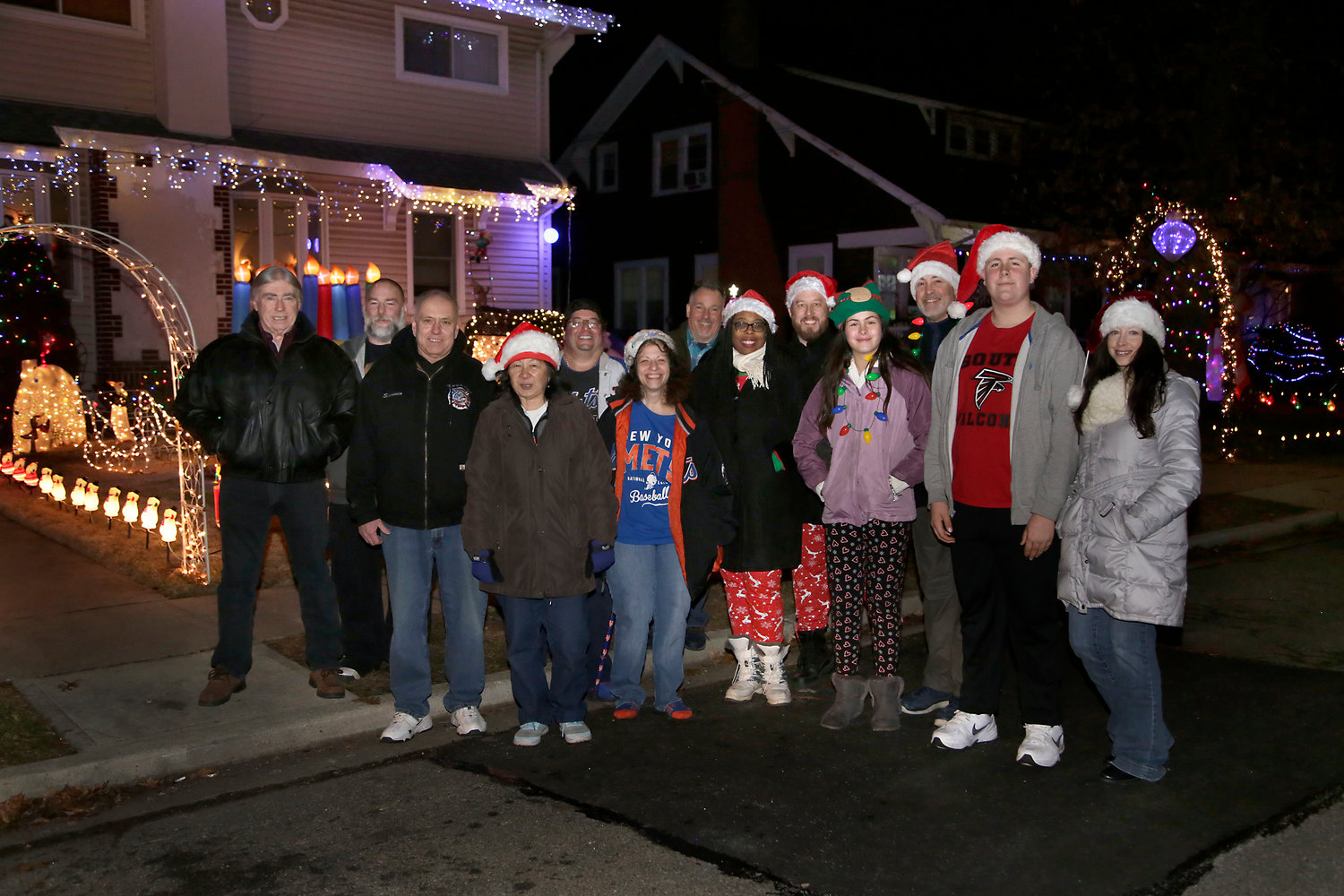 Sylvan Place neighbors John McGovern, from left, Stephen Carr, Wally Schroeder, Carole Schroeder, Alex Carr, Sheryl Carr, Dino Fino, Sherise Dowling, Thomas Dowling, Jessica Dyer, Rich Dyer, Christian Dyer and Erin Ann McGovern at their 2019 Christmas block party fundraiser.