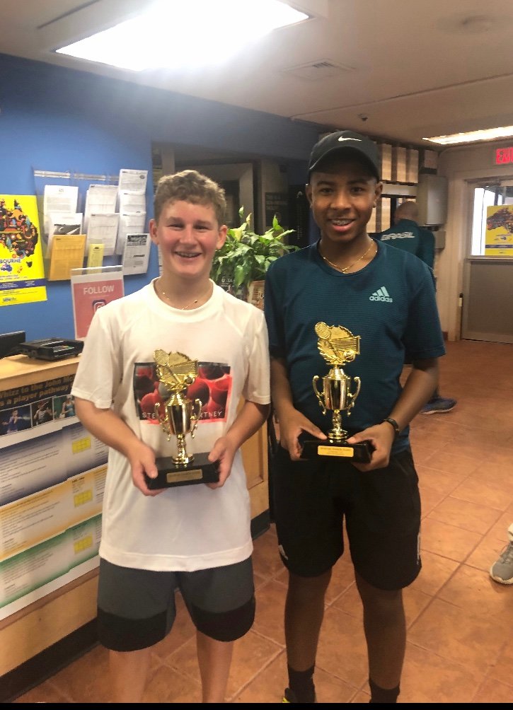 Schorr, left, and his partner, Zavier Augustin of Malverne, with their doubles trophies.