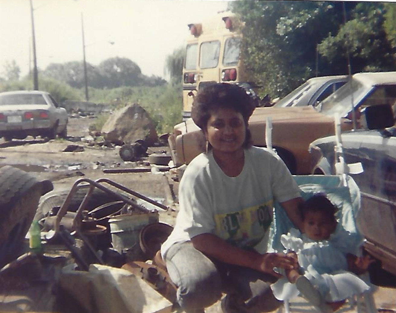 Longtime Valley Streamer Orville Davis — the toddler at right — with his mother, Sonia, at his father’s Queens scrapyard, circa 1990. Davis now has his own eco-friendly scrap-hauling business.