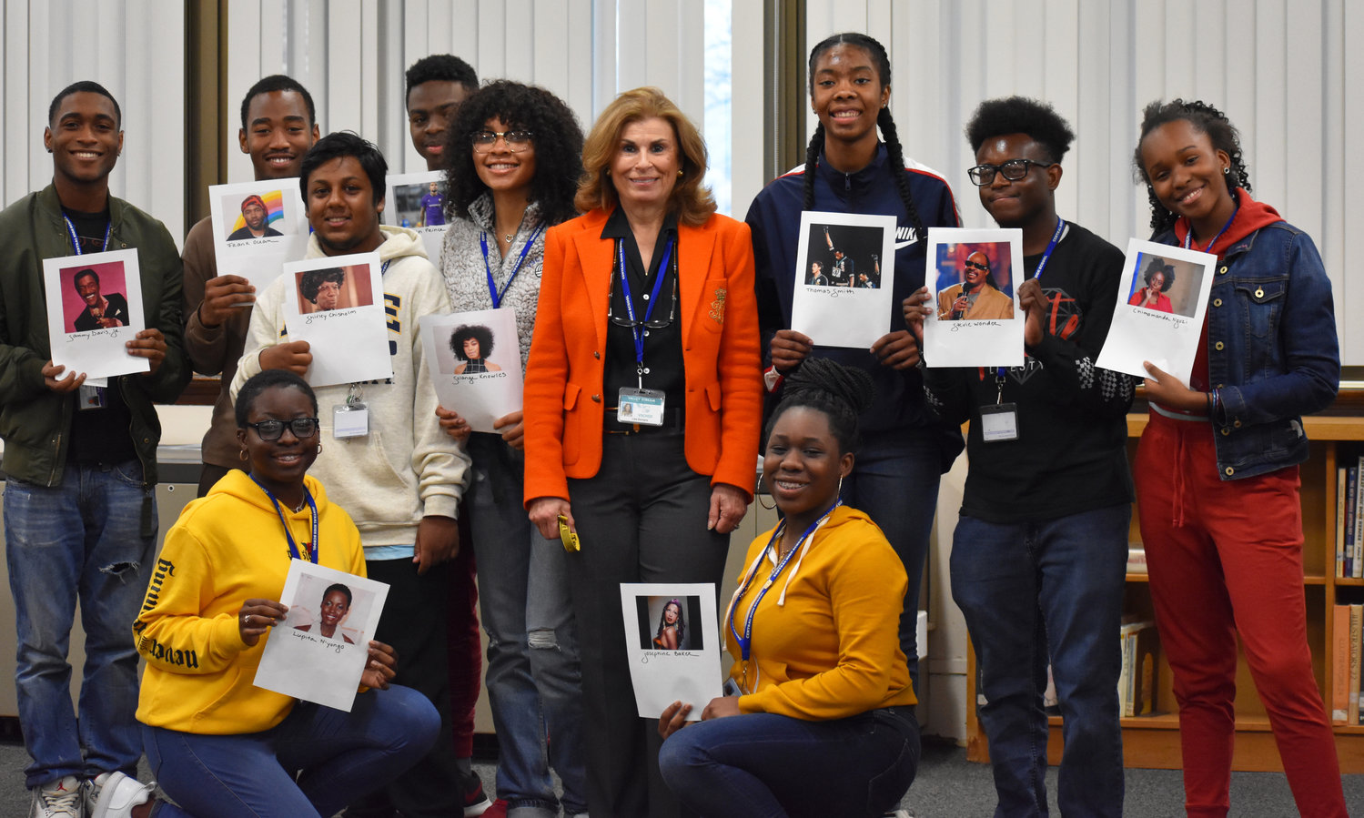 Ten Central High School students gathered in the school library on Feb. 13 to give presentations on black figures that inspire them. With them, at center, was library Media Specialist Lisa Dichiara.