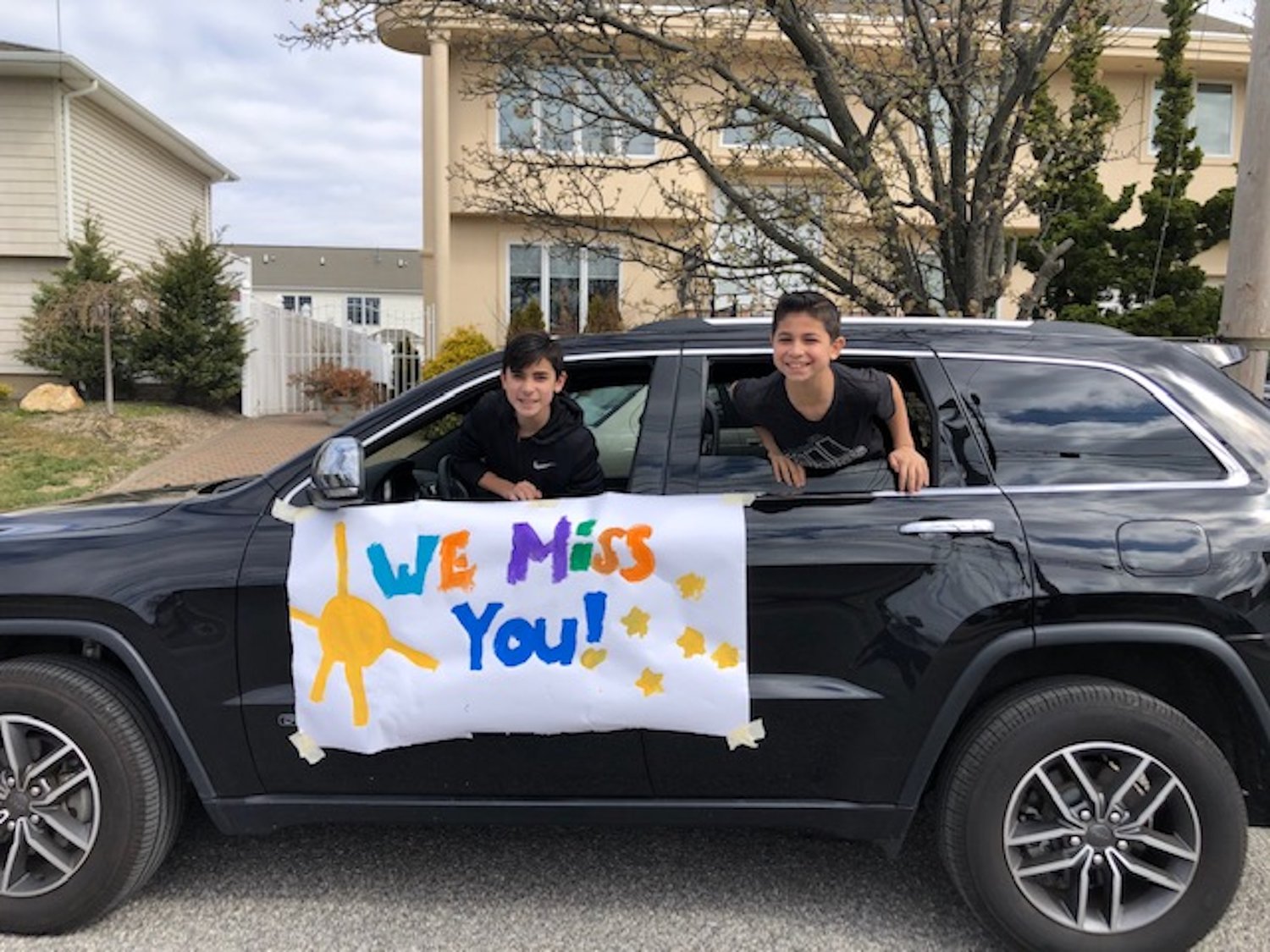 Brothers Jayden, 12, and Jared Eisenberg, 10, used their parents’ car to send a special message to their teachers.