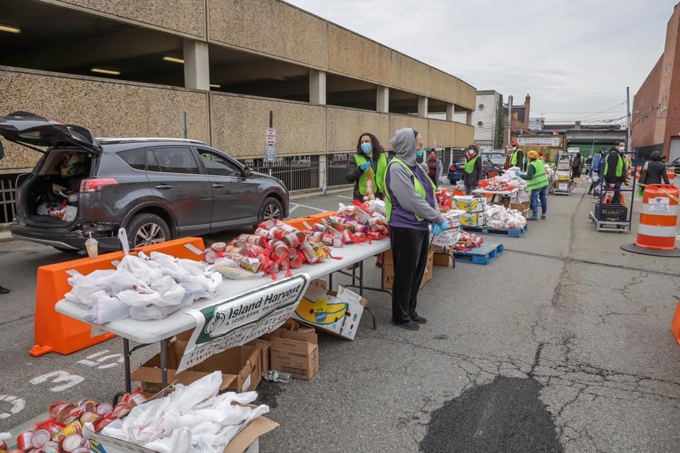 Island Harvest Food Bank partnered with Nassau County to distribute food at nine different county sites on April 23. Above, volunteers were helping deliver the food to residents and families in Hempstead Village.