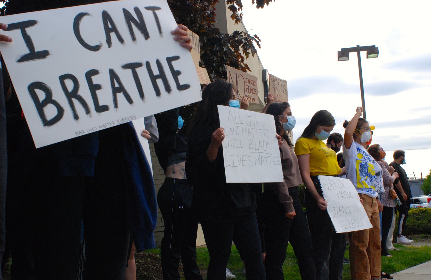 Many protesters wrote "I can't breathe" on their signs. George Floyd died after a Minneapolis police officer pressed his knee into his neck for more than eight minutes. Floyd had pleaded with the officer, telling him that he could not breathe.