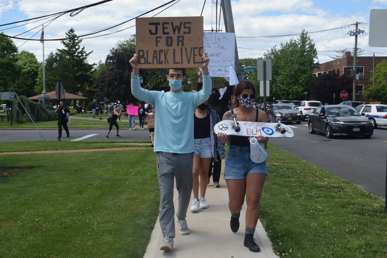 March organizers Shua Auerbach, left, and Lina Mavruk led the procession on Cedarhurst Avenue last Sunday.