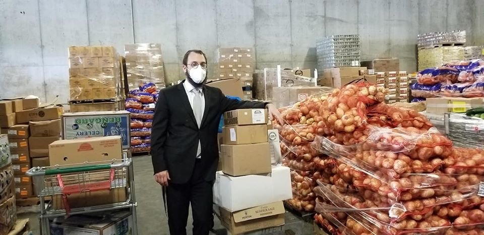 Rabbi Nochem Tenenboim with the food donated by a Hewlett Harbor resident  that was distributed to people in need in the Five Towns and Queens.