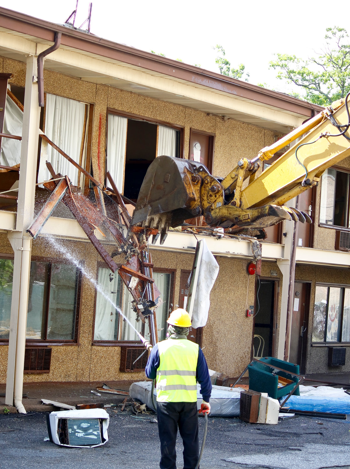 Terwilliger & Bartone Properties started tearing down the Capri motel on Monday, above left, after coronavirus restrictions on construction were lifted.