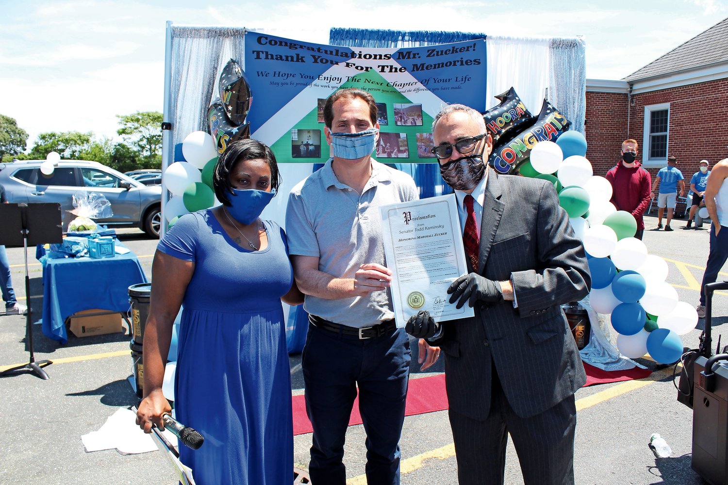 Gotham Avenue Principal Marshall Zucker, right, received a proclamation in honor of his retirement from State Sen. Todd Kaminsky on June 16. They were with Parent Teacher Association President Natasha Appleby.
