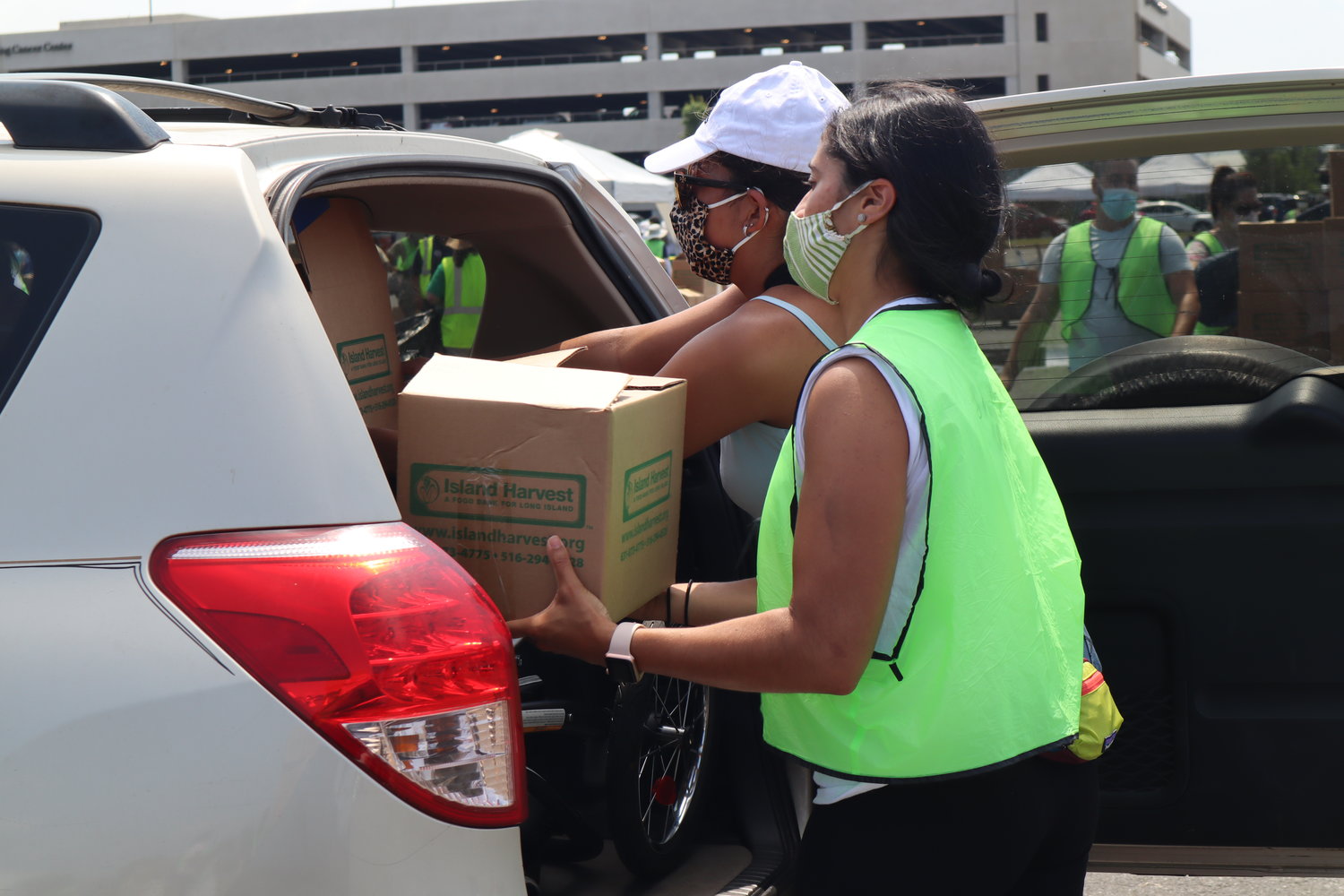 Brittany Baez, in green, of Rockville Centre, filled up a car with Jackalyn Gonzalez, of Amityville.