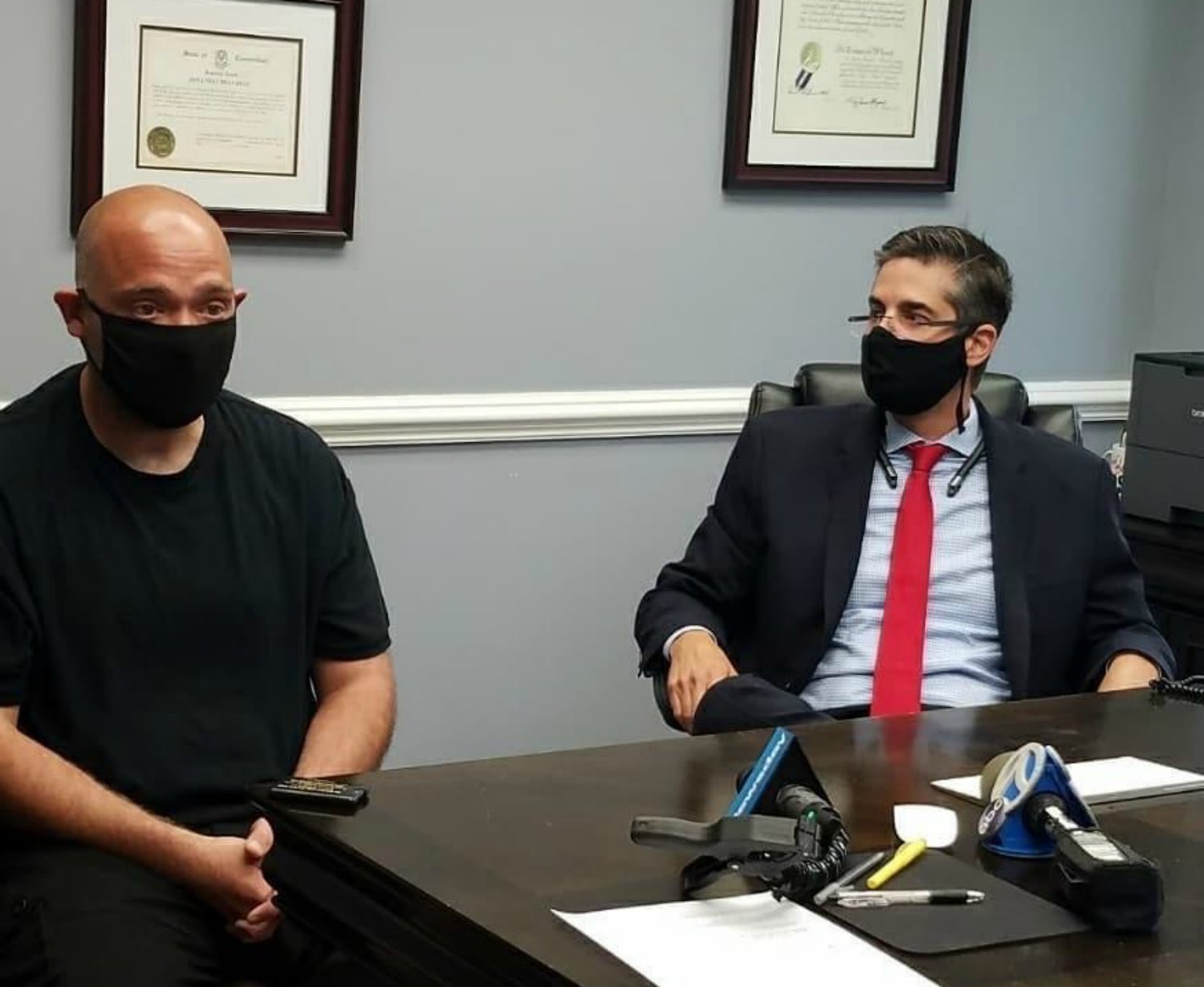 Thomas DeSarle, left, and Jonathan Bell of Bell Law Group participating in a press conference regarding an alleged incident at the Glen Cove Carvel where DeSarle was left without a job after refusing to take money from a customer who was not wearing a mask.