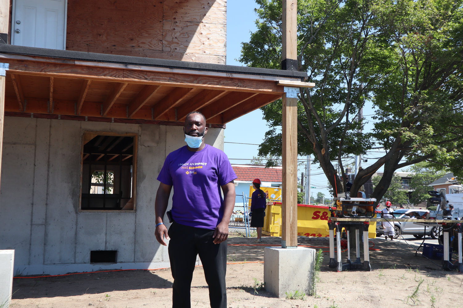James Hodge in front of his home at Riverside Boulevard and East Fulton Street, which is being rebuilt with the help of local volunteers.