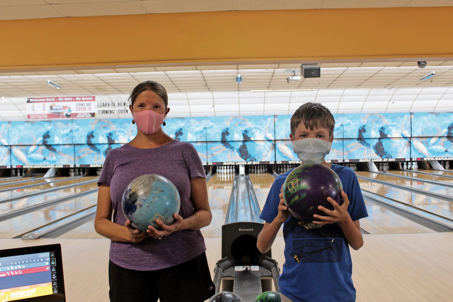 Liz Bonney, left, and her 11-year-old son, Matt, returned to Maple Lanes on Monday for an afternoon of bowling.