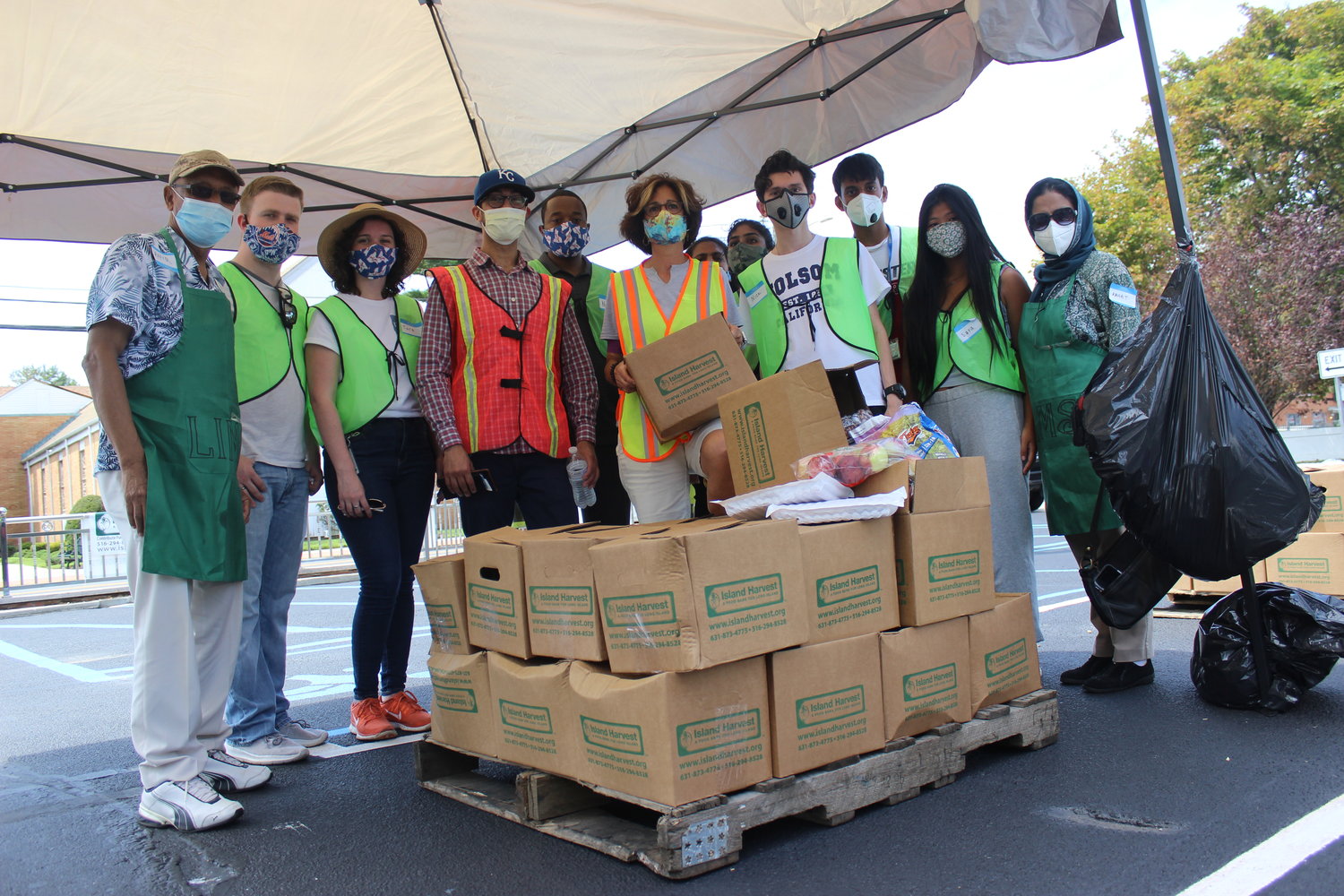 Volunteers from Island Harvest and the Long Island Muslim Society, in East Meadow, handed out boxes of food to roughly 150 local families during a joint food distribution event at the mosque last Saturday.