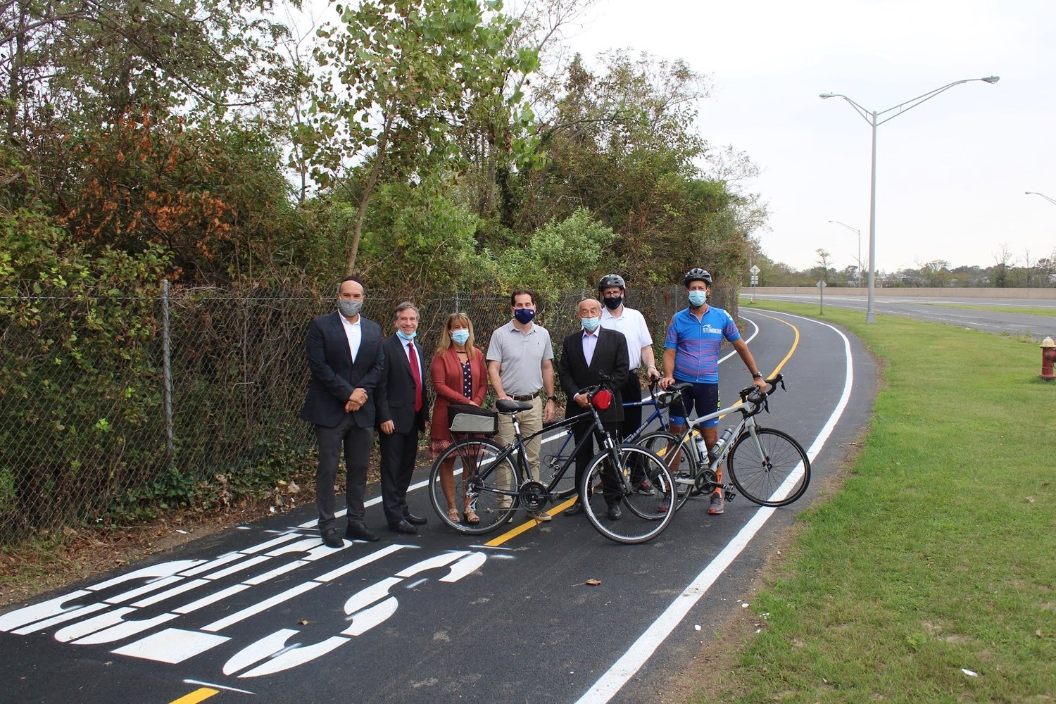 The Nassau Expressway bike path approaching the Seagirt Boulevard exit heading southbound has been repaired. From left, Deputy Mayor of Lawrence, Michael Fragin, Lawrence Trustee Uri Kaufman, Assemblywoman Missy Miller, State Sen. Todd Kaminsky, Lawrence Mayor Alex Edelman, Lawrence residents/cyclists Yosef Nussbaum and Mark Rubin.