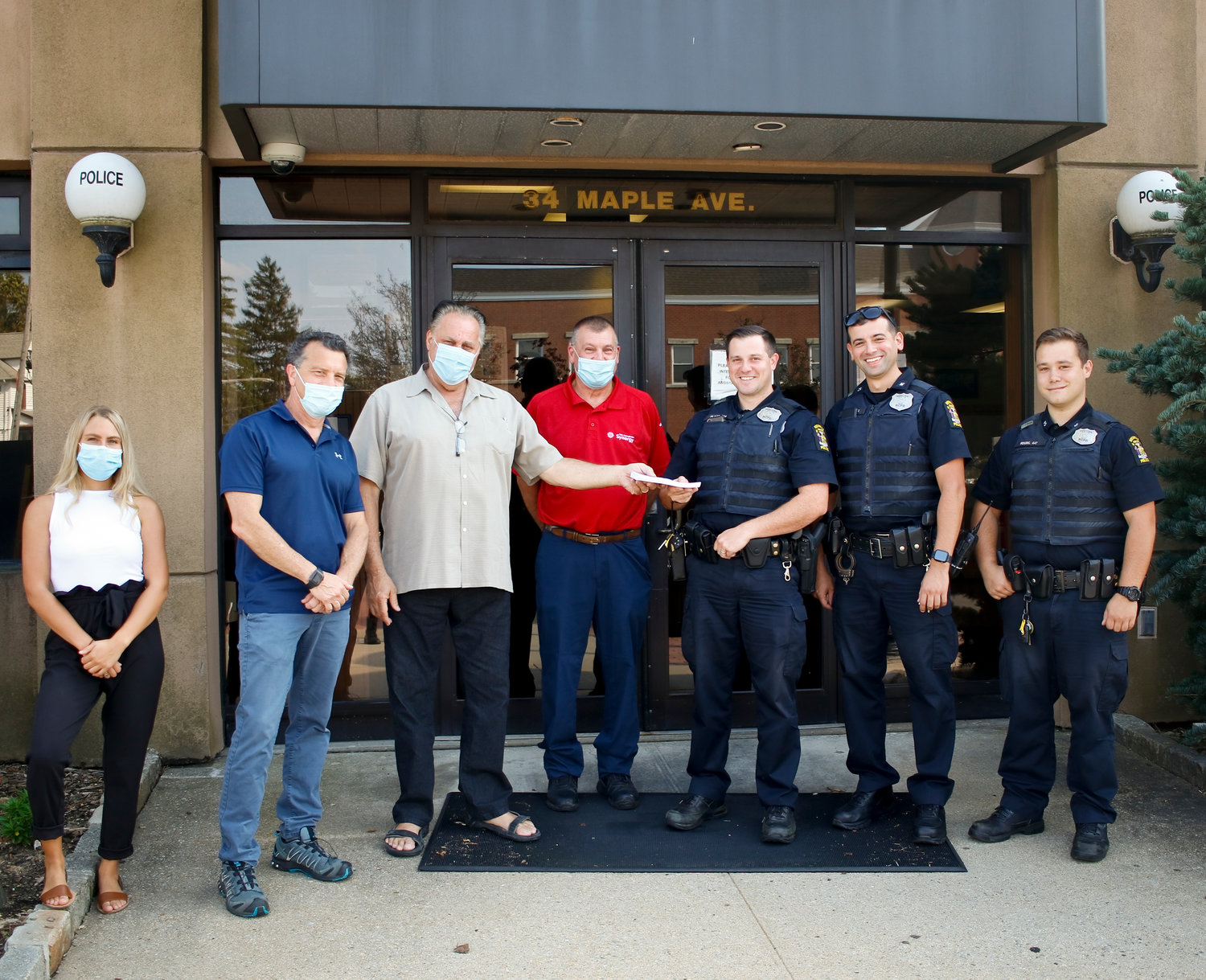 Anton's Car Care Center and Herald Community Newspapers donated a $15 gas coupon to every officer of the Rockville Centre Police Department on Aug. 28. Courtney Myers, Event Coordinator, left and Stuart Richner, Publisher, from Herald Community Newspapers, Anton Parisi, President and Harry Redes, Vice President from Anton's Car Care Center with RVCPD Officers, from left, Ron Flood, Chris Martins and Phil Kouril outside of Police Headquarters on Maple Ave.