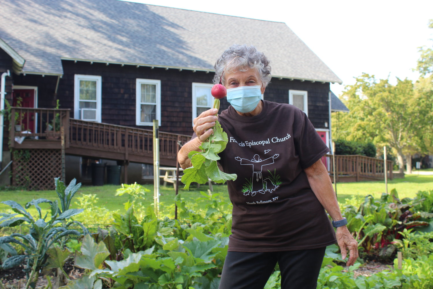 Camille Gaynor showed off a deep pink radish pulled fresh from the garden at St. Francis Episcopal Church in North Bellmore.