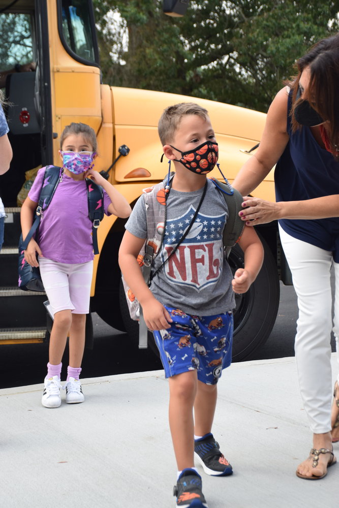 Students greeted the new school year with confidence as they made their way from the bus.