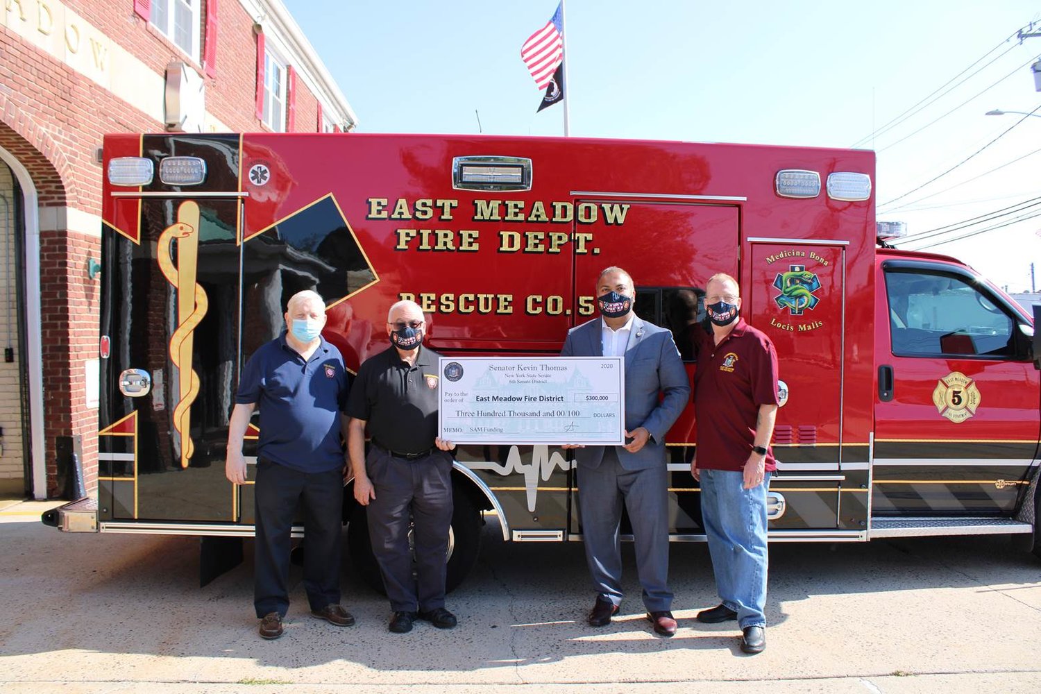 East Meadow Fire District Treasurer Raymond L’Hommedieu, left, was with Commissioner Carey Welt, State Senator Kevin Thomas and Commissioner John Priest after Senator Thomas gave them a check for a $300,000 grant to replace two department ambulances.