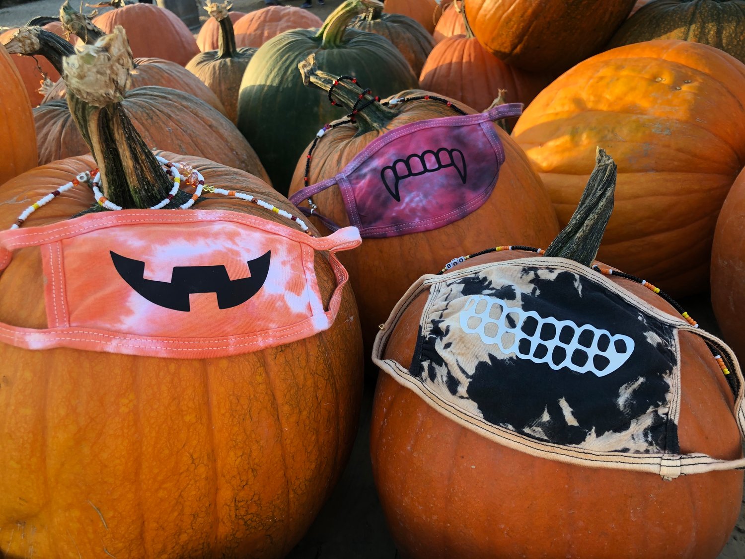 Two local entrepreneurs are using their new businesses to raise money for breast cancer awareness. Above, masks that were made by Marion Schwaner as part of her To Tie-Dye for Clothing business.