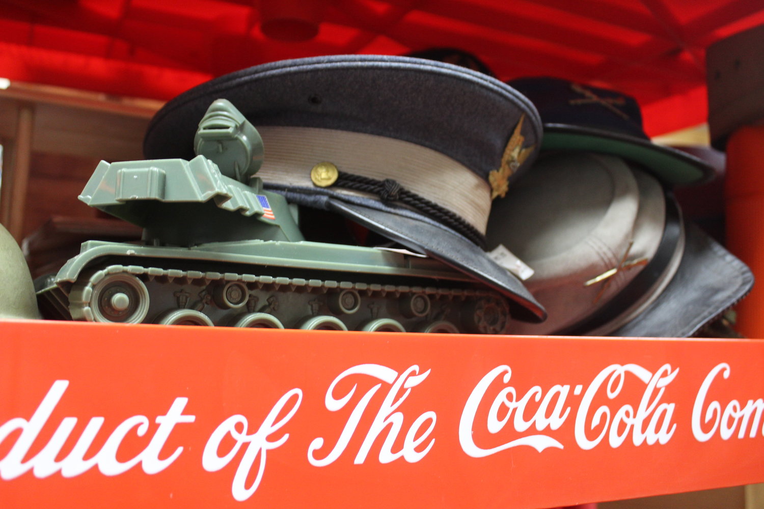 Keepsakes from the Korean and Vietnam wars sit on a 1950s-era Coca Cola shelf.