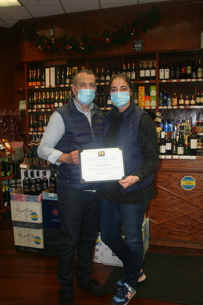 Fine Wine and Spirits owners Bobby, left, and Zaide Ostrozubi said they were proud to support CASA’s mission.