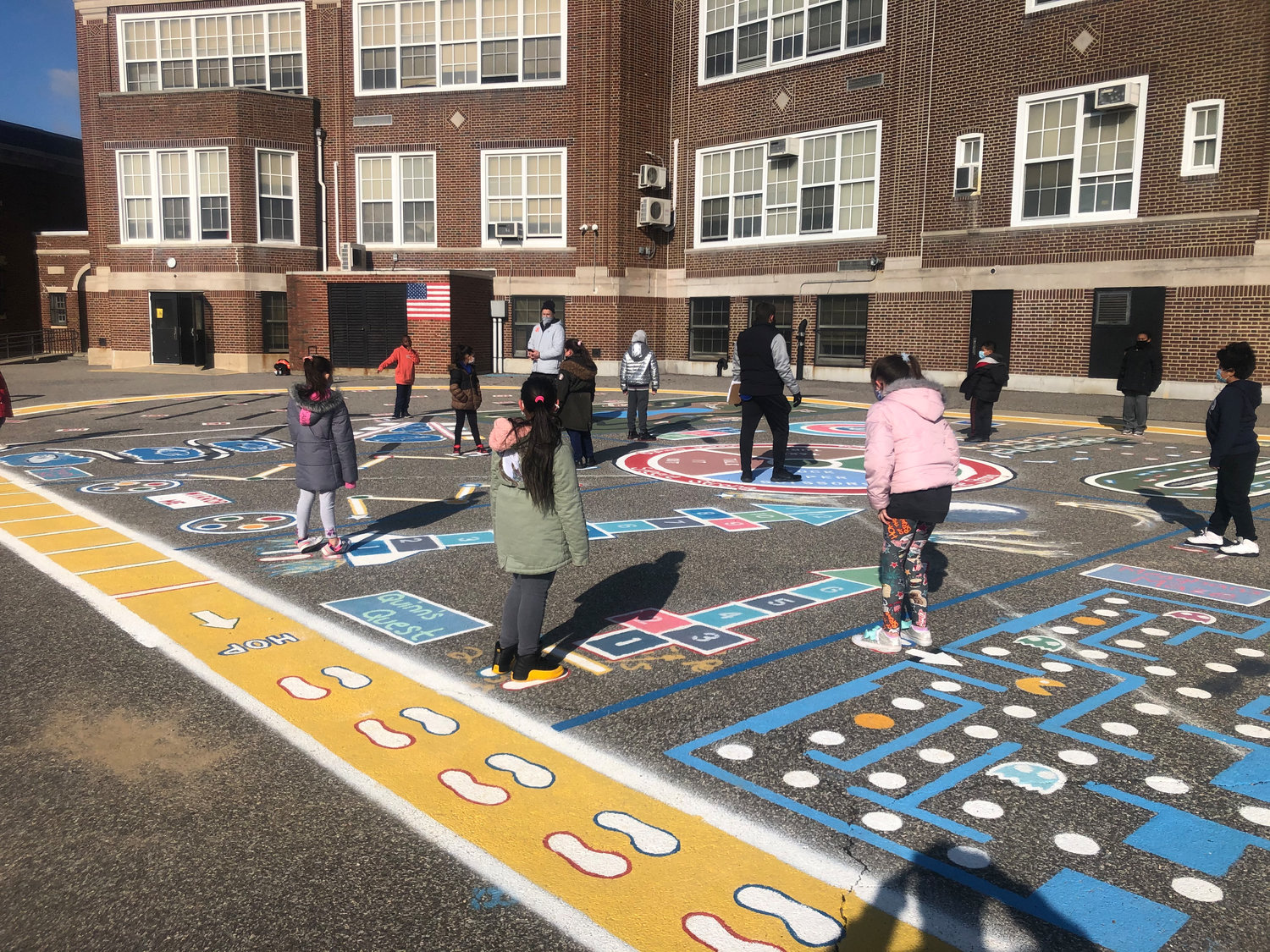 Thinking outside the blacktop box: Steele Elementary School students took part in a variety of fitness exercises after physical education teachers Joseph Billi and Richard Garguilo created a blacktop activity wheel in the schoolyard using paint and cardboard box stencils.