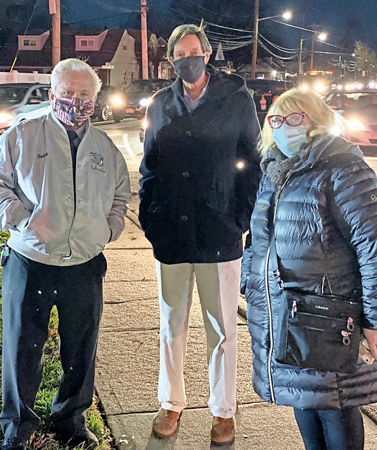 Julie Marchesella, right, has helped run the Elmont Chamber of Commerce’s annual Christmas tree lighting ceremony over her 25 years as a chamber member. She was with board members Ralph Esposito and Pat Boyle at the ceremony in December.