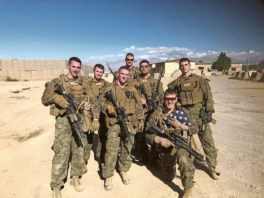 Sgt. Ben Hines, far left, Sgt. Christopher Slutman, back center, and Sgt. Robert Hendriks, far right, were killed by an improvised roadside explosive device that detonated near their vehicle in Afghanistan.