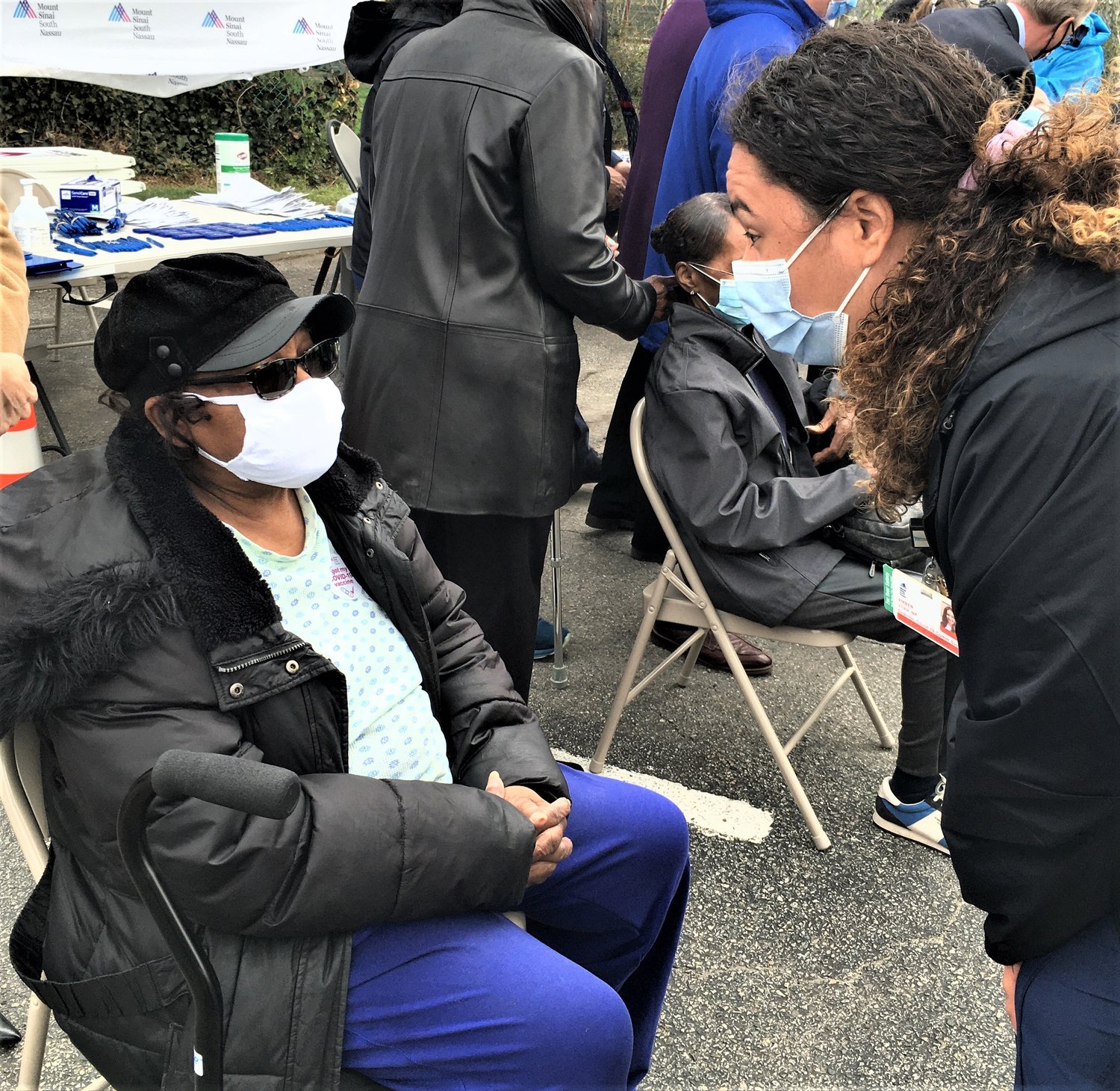 After her vaccination, Elizabeth Haggood, of Uniondale, received instructions from Amber Vitale, director of the Pandemic Department at Mount Sinai South Nassau.