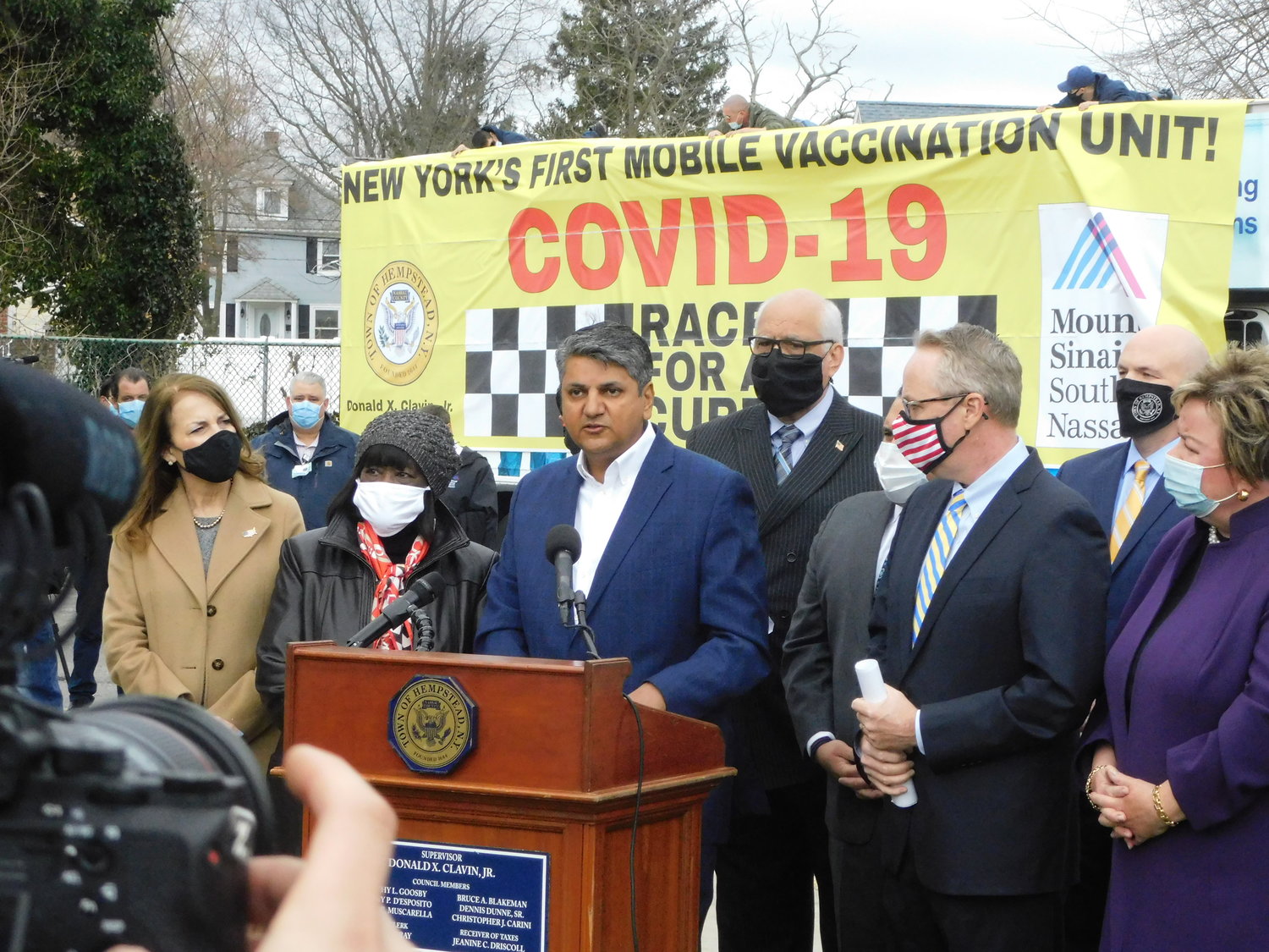 Dr. Adhi Sharma, chief medical officer at Mount Sinai South Nassau, stood with Town of Hempstead government officials at the unveiling of the Vaxmobile.