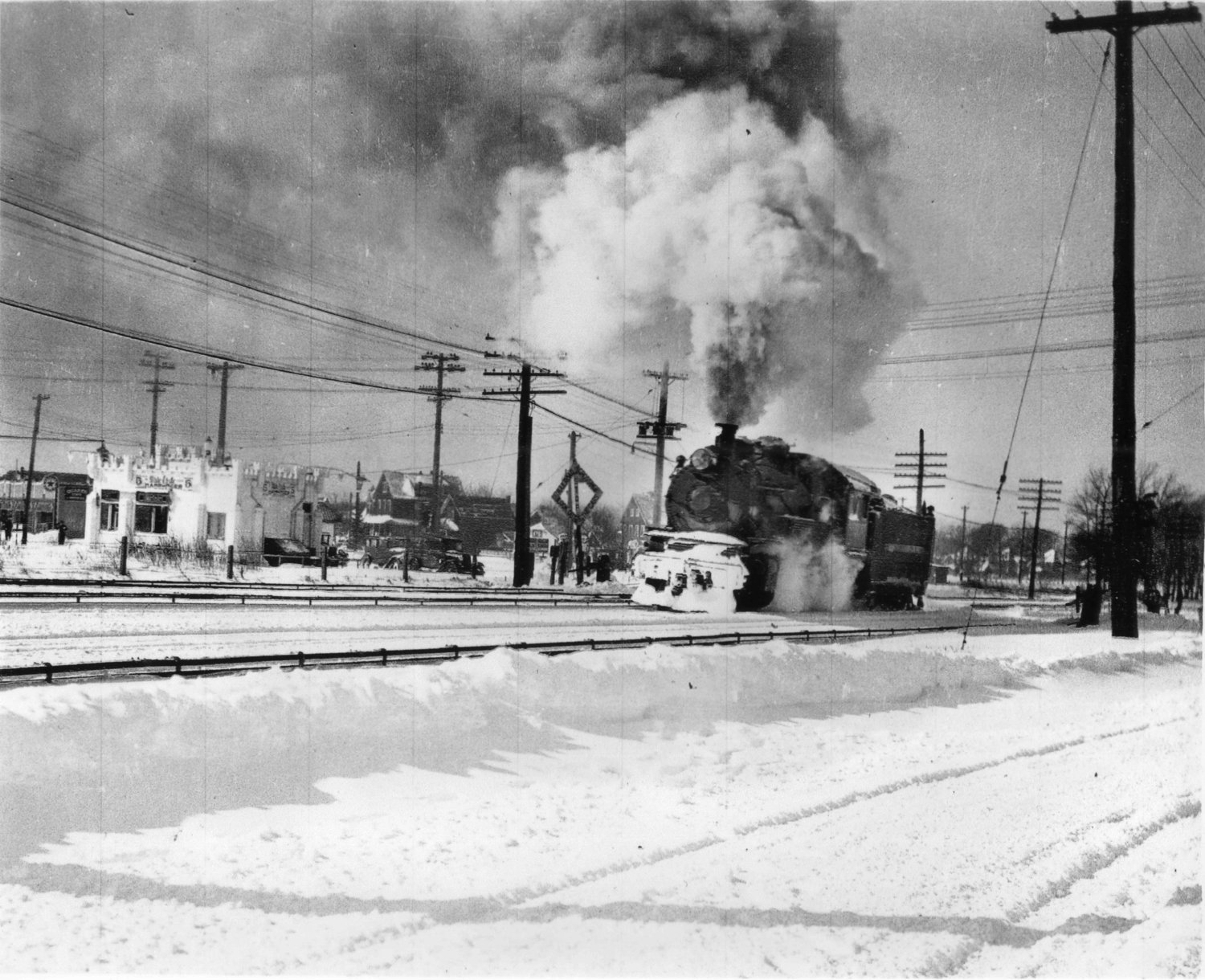 A Long Island Rail Road steam train crossed Broadway near White Castle in the 1930s.