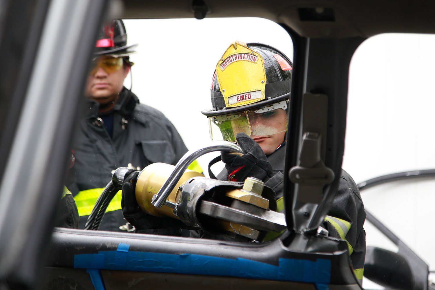 Firefighter Ionut Koshar, of Ladder 1, cut through an SUV’s window frame in one of the demonstrations.