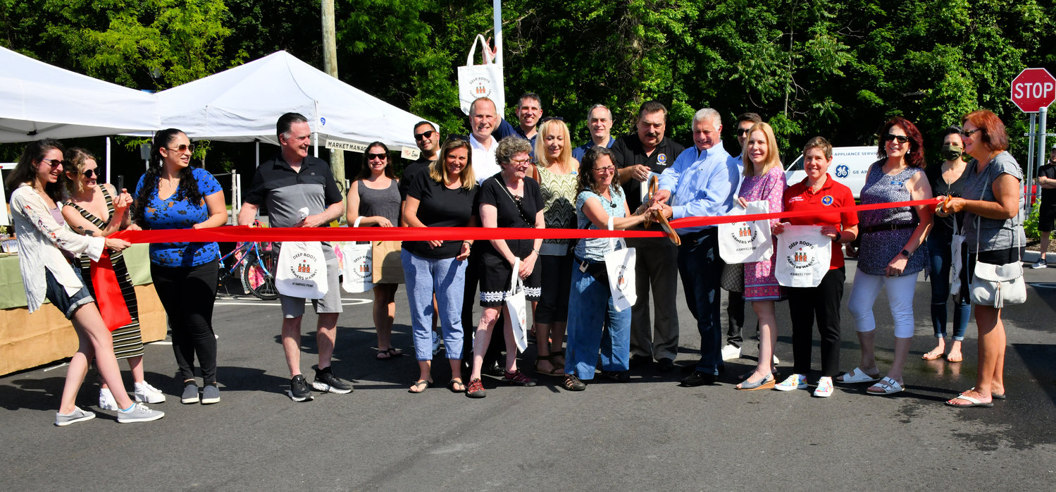 Deep Roots Farmers Market opened with a ribbon cutting on Saturday morning at its new location at 100 Garvies Point Road.