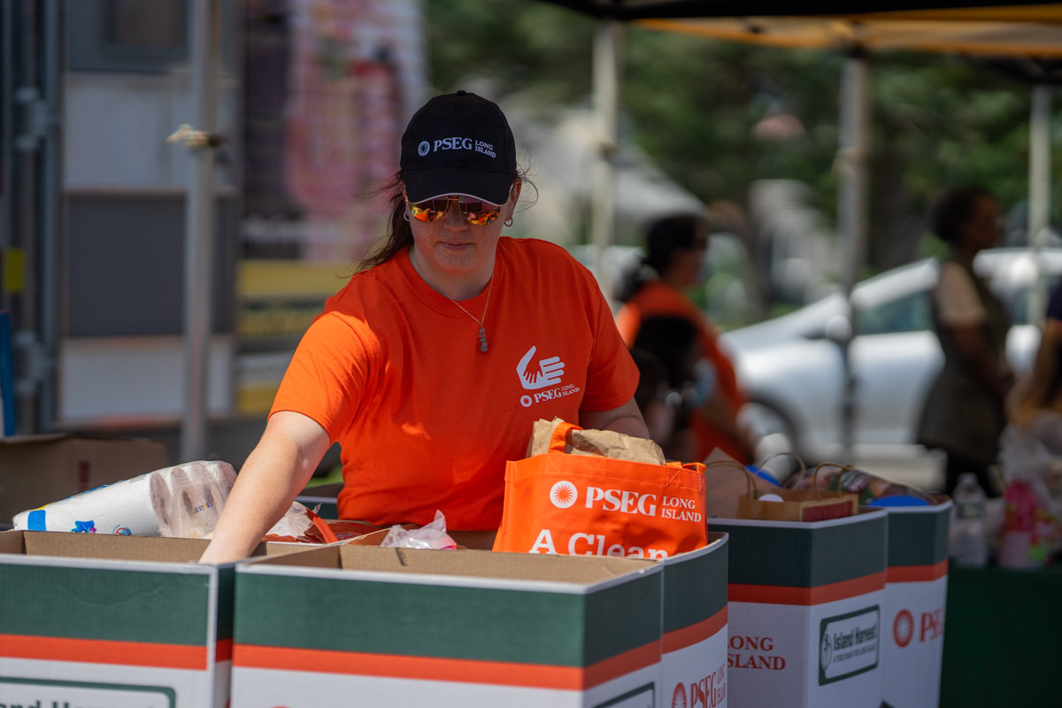 PSEGLI volunteer Kyra Bella helped sort food in bins as people donated.