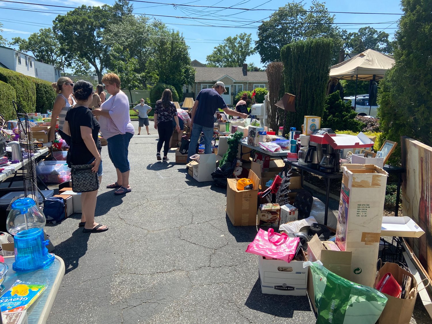 Friends, family and neighbors offered Justin Weiss money and other donations at his garage sale on Saturday.