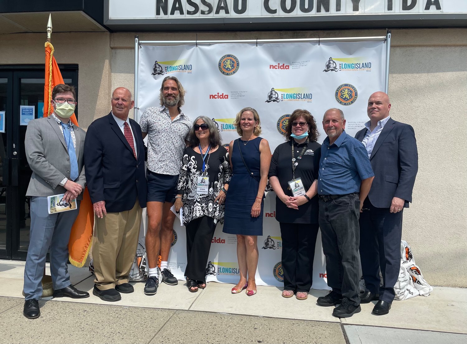County Executive Laura Curran, center, kicked off the Long Island International Film Expo on Tuesday with, from left, Jared Fishedick, Richard Kessel, Lukas Hassel, Debra Markowitz, Bellmore Movies owners Anne and Henry Stampfel and Harry Coghlan.