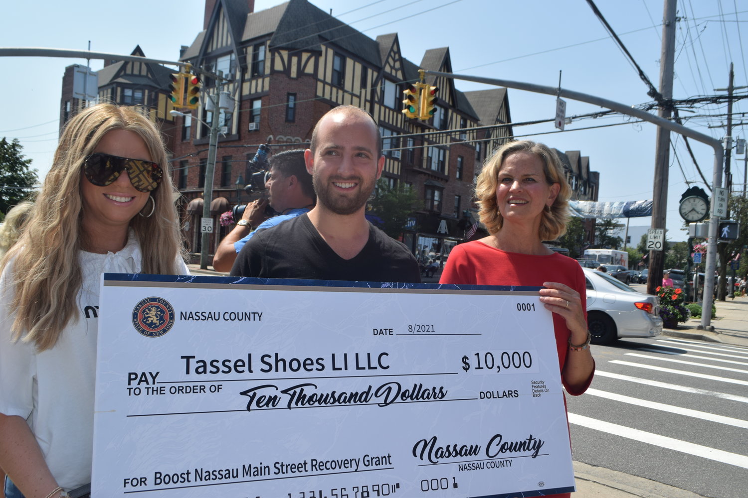 Zzipora and Aaron Shapiro, the wife and husband who own Tassel Children’s Shoes in Cedarhurst, are the first recipients of the Main Street Recovery Grant. At the far right is Nassau County Executive Laura Curran.