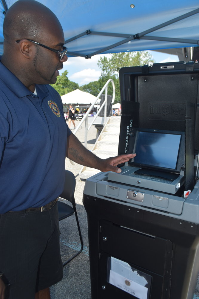 Nassau County Board of Elections voter outreach and education demonstrator Abraham Haygood showed how to use a voting machine.