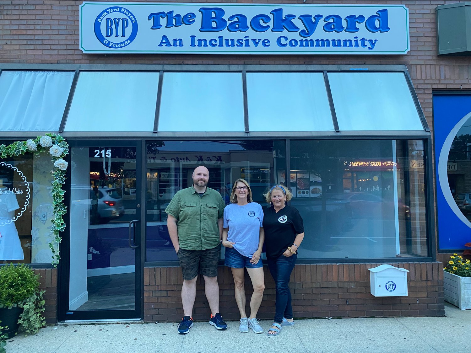 Backyard Players Co-founders Ryan Delaney, Cristina Daly and Ellen White in front of their new building, which will enable them to bring art and theater programs to students in the Special Education Department.