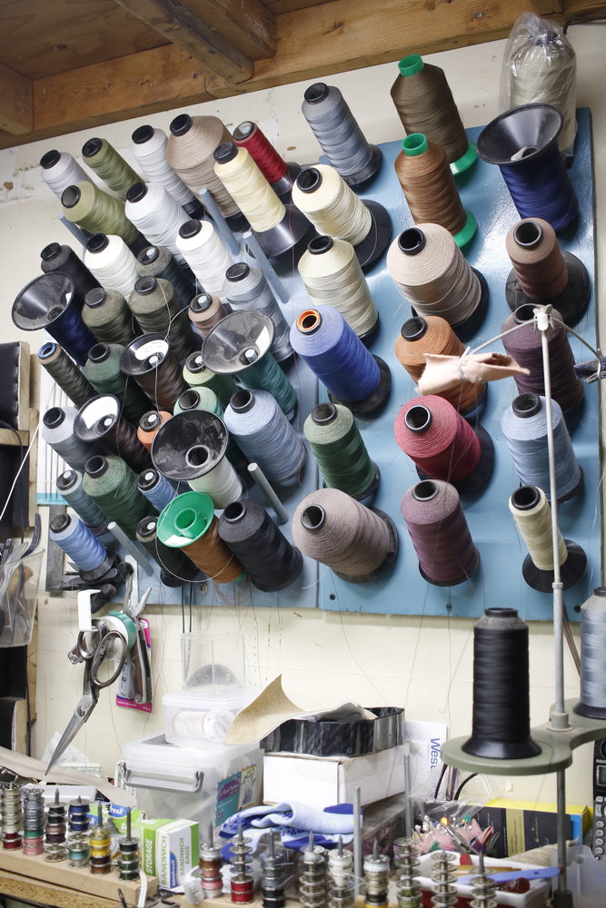 There are all kinds of swatches and spools of colorful thread to entice customers.