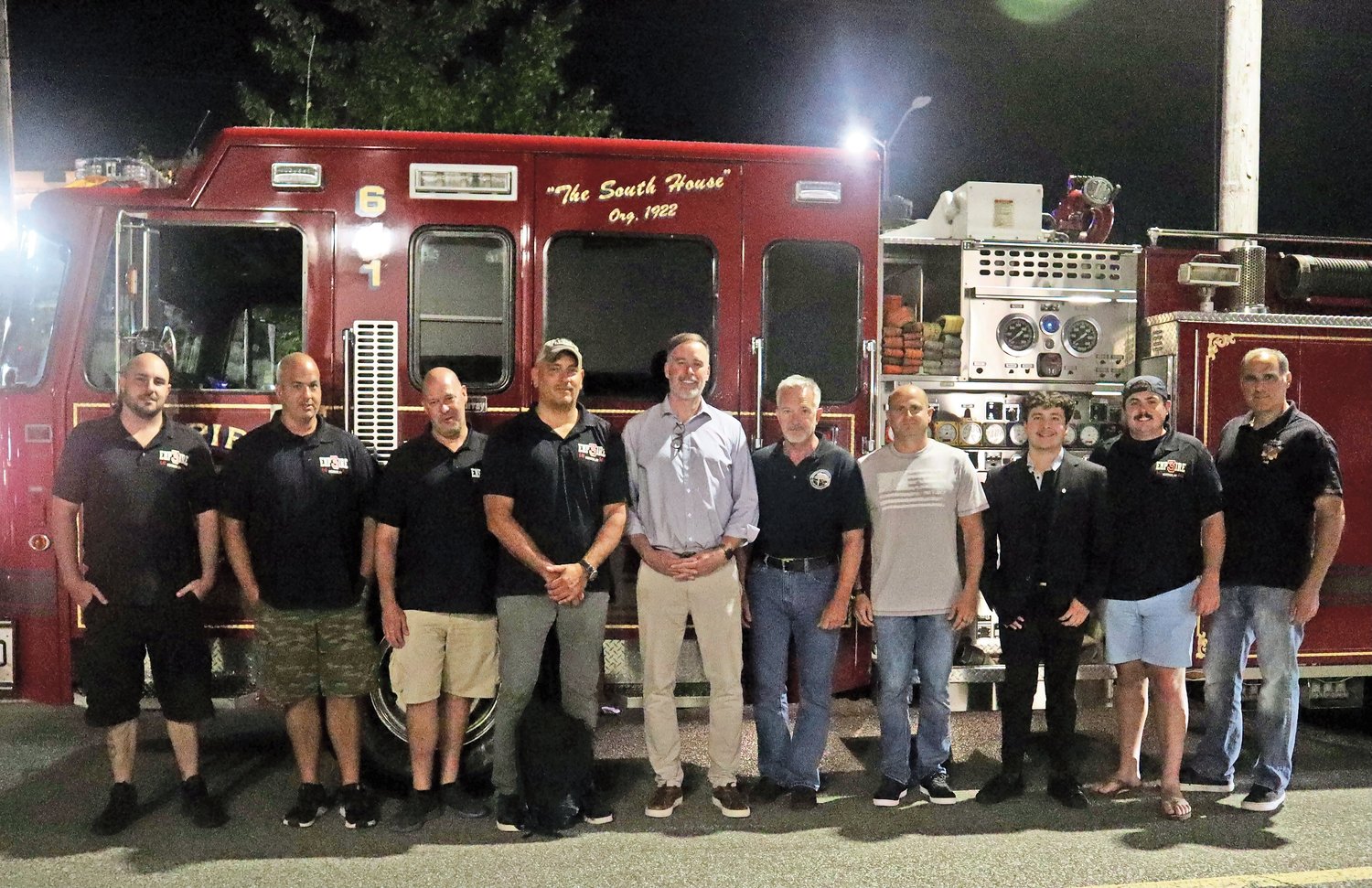 CIA Senior Paramilitary Officer Phil Reilly and Counter-Terrorism Operator Gary Harrington, center, with members of the Merrick Fire Department at the screening of “CIA vs. Bin Laden: First In,” on Aug. 31.