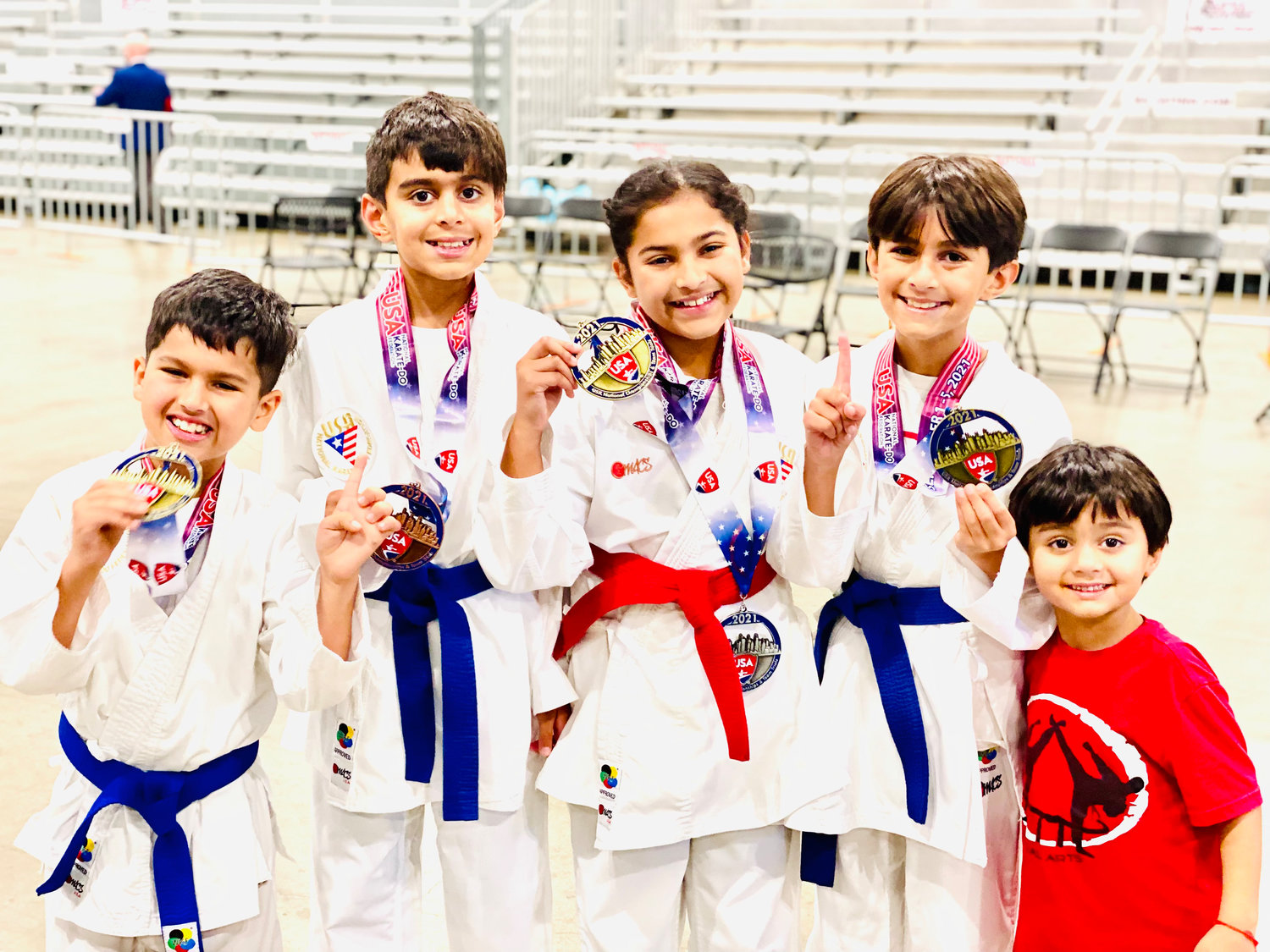 Siblings and cousins Jai, Rohan, Sonali and Deven Chopra all earned medals at this year’s national karate championships outside Chicago. Rohan and Deven’s brother Krish, far right, rooted his brothers on at the elite competition.