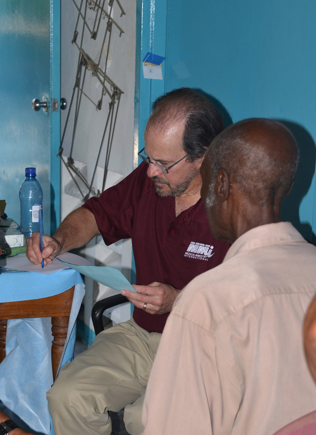 Dr. Robert Appel with a patient on a mission to Haiti in 2015.