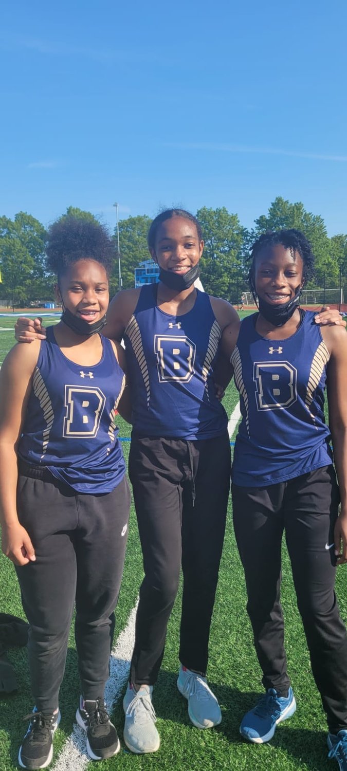Middle-schoolers Sariah Doresca, 14, right, and Jillian Rickford, 14, left, competed alongside Jahzara Emeli, center, with the Baldwin High School team.