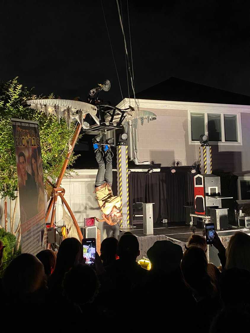 Magician Eric Wilzig escaped from a strait jacket and metal jaws before a huge crowd in front of his Oceanside home.