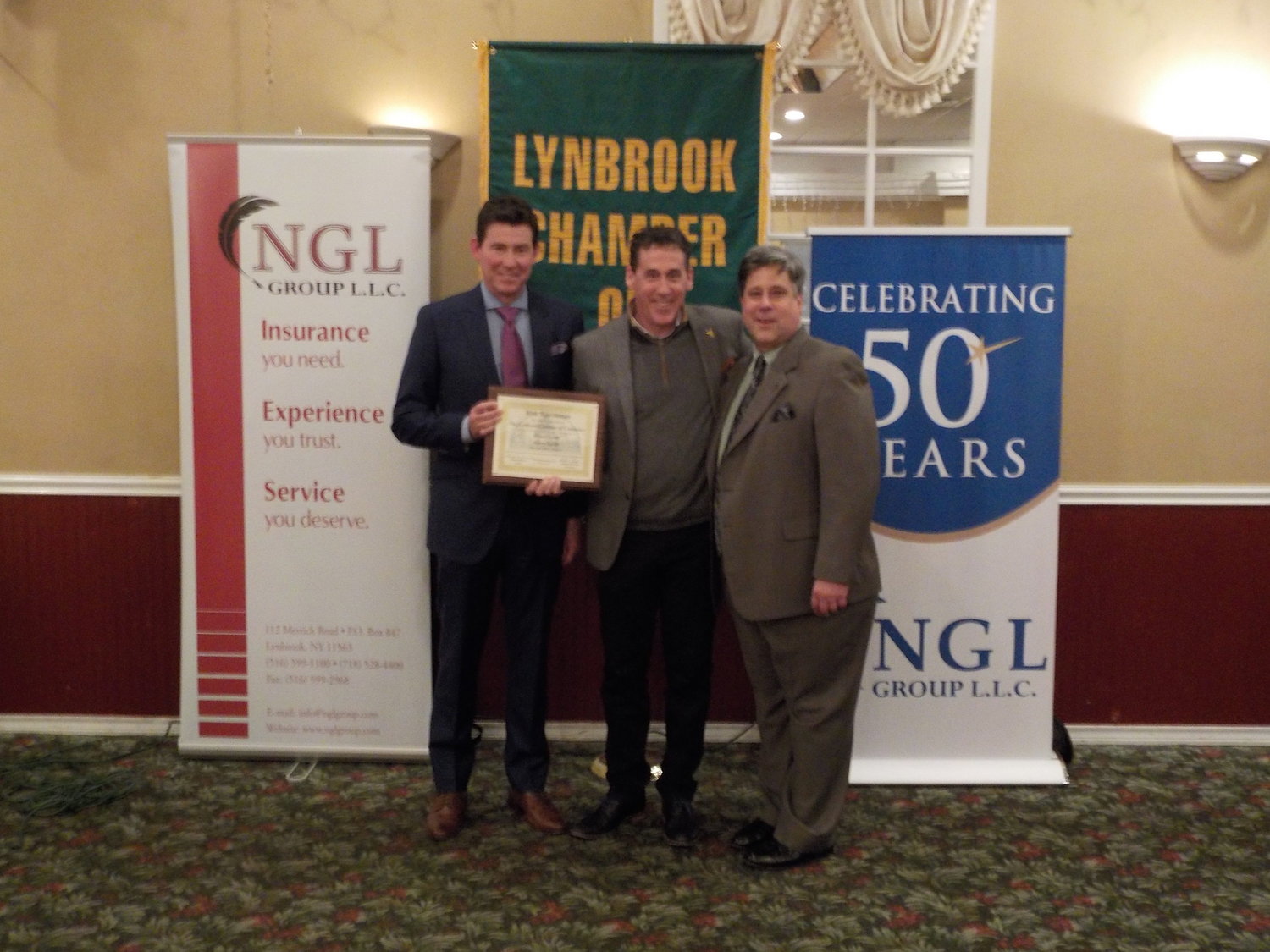 Bruce Levitt, left, and his brother, Harry, center, were honored when their business celebrated 70 years in 2017. With them was former Lynbrook Chamber of Commerce President Stephen Wangel.