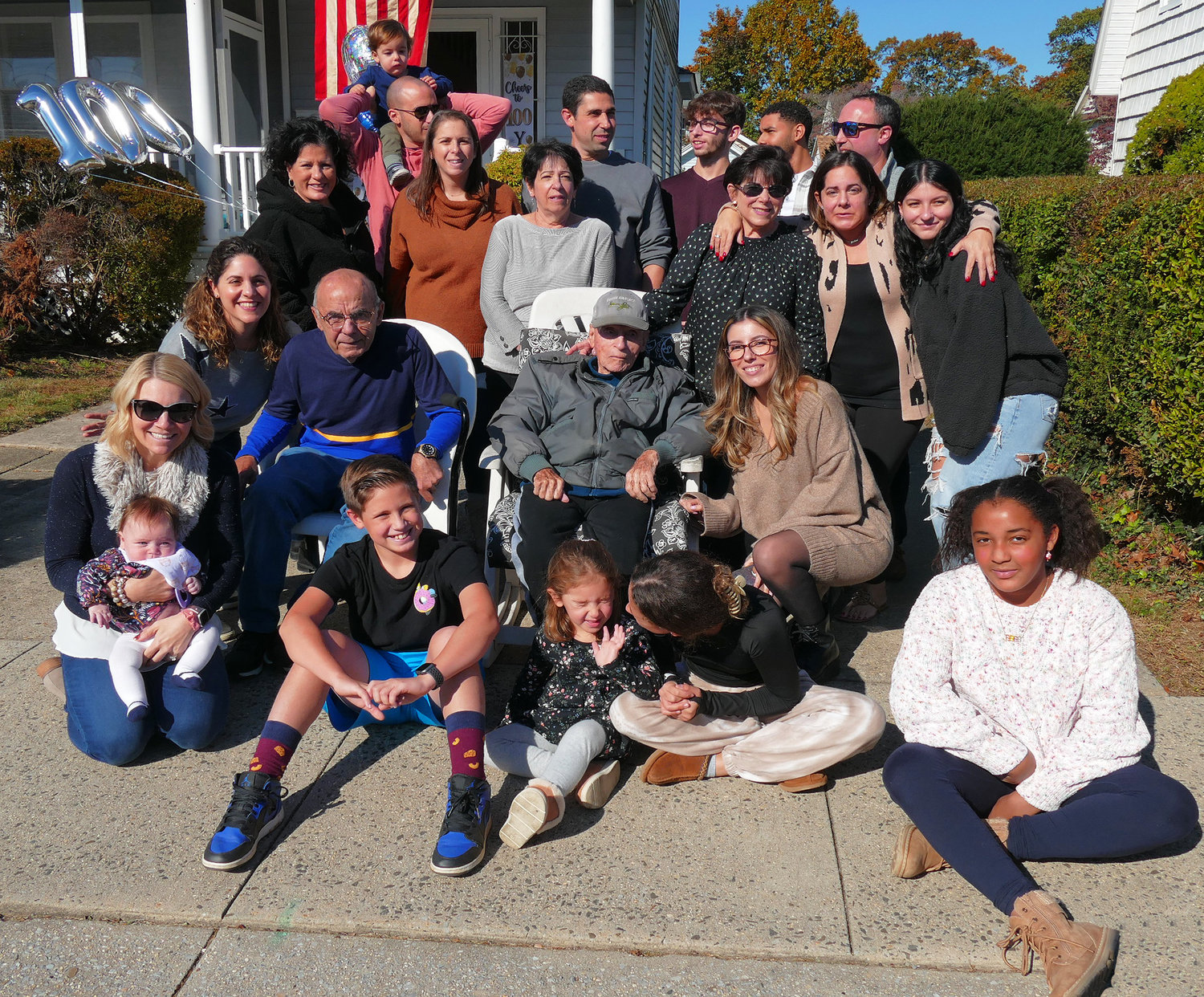 Herbert Rosenberg surrounded by family and friends in front of his home on the Rockville Centre-Oceanside border.