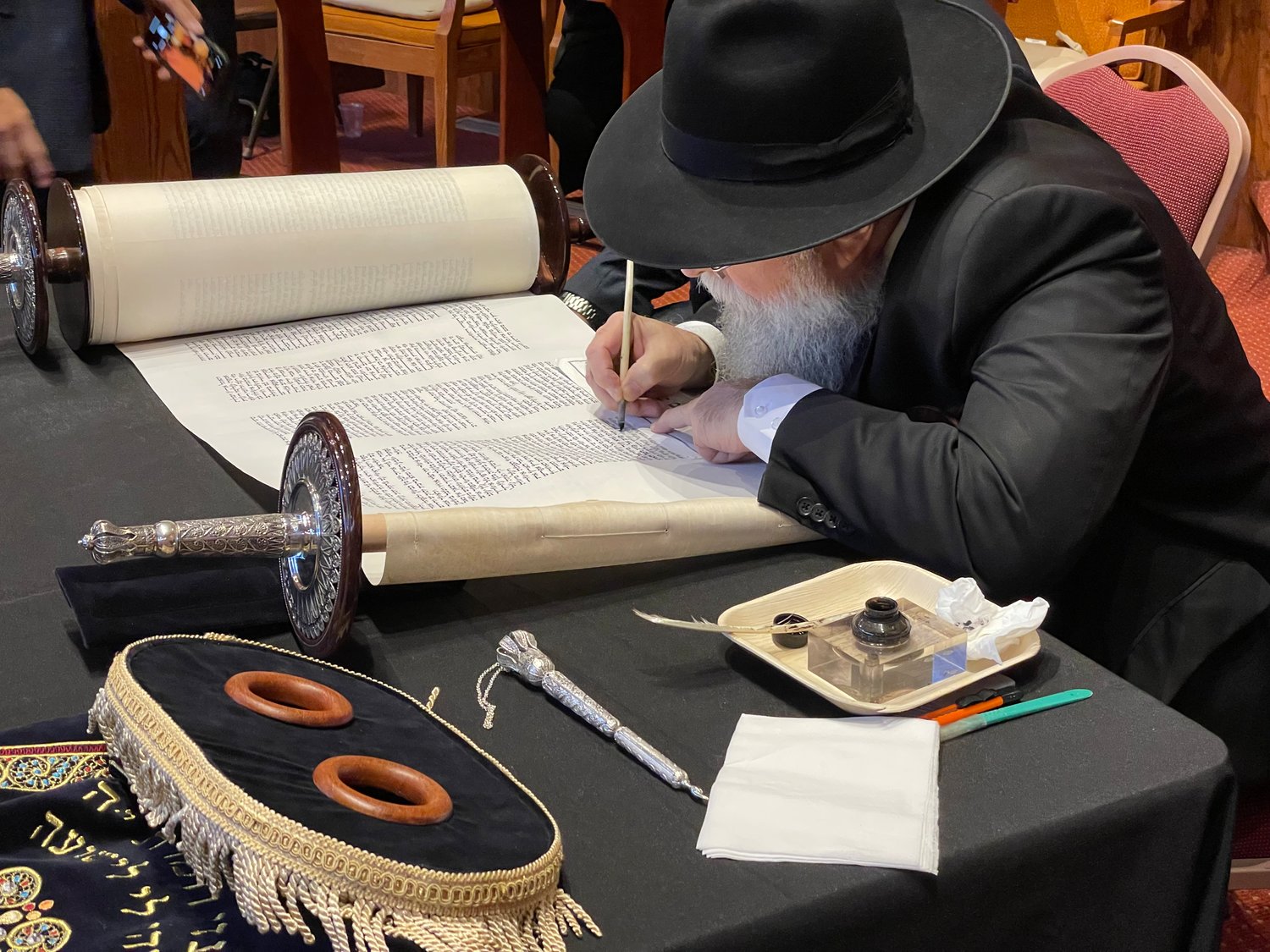 At Congregation Ohav Shalom on Sunday, Rabbi Pincus, a renowned sofer — a traditional Jewish scribe — completed the final 100 letters of a new Sefer Torah, in memory of Merrick resident Samuel Adwar.