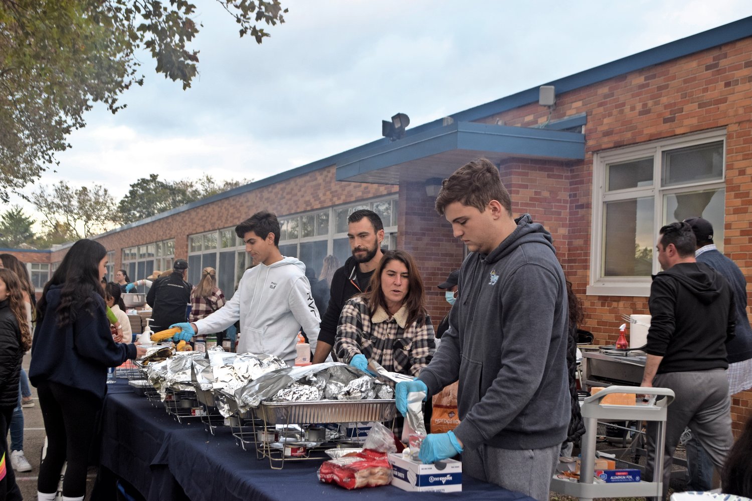 Volunteer parents and older Hewlett-Woodmere students helped to serve the food at the fall festival.